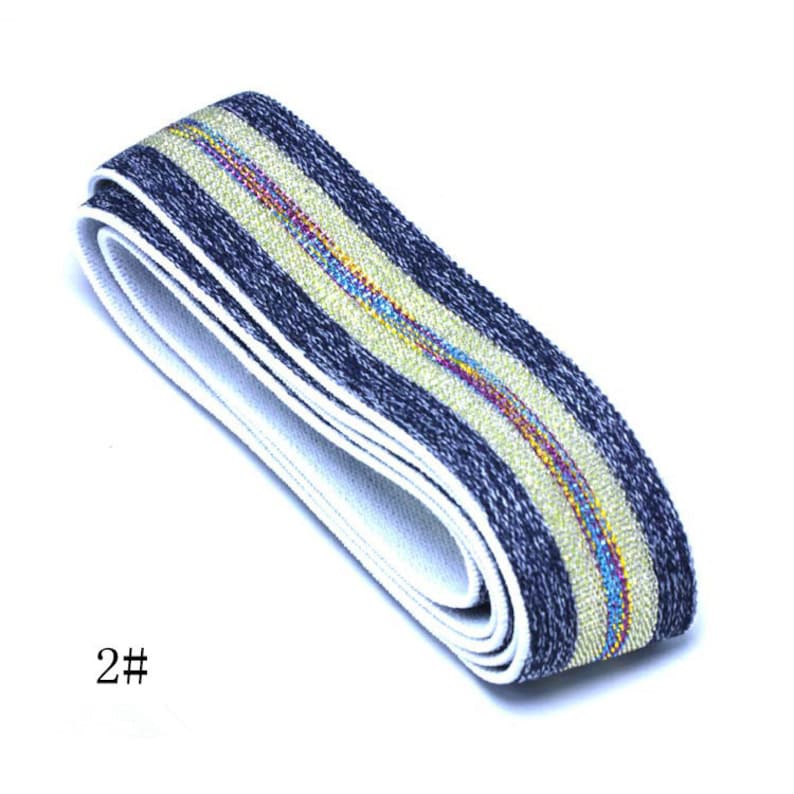 May include: A close-up of a blue and white elastic band with a gold stripe. The band is folded in half and the gold stripe is visible on both sides.