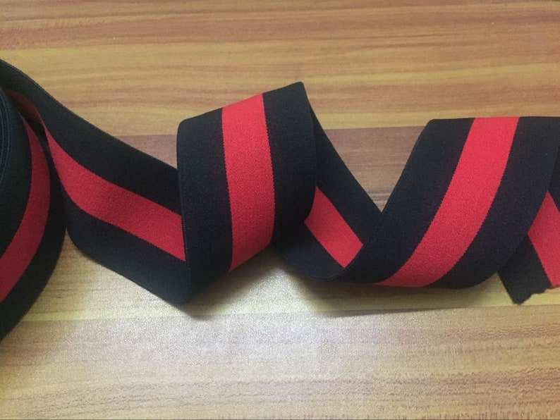 May include: Black and red striped elastic trim. The trim is made of a soft, stretchy fabric and is perfect for adding a pop of color to your sewing projects.