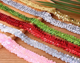 May include: Assortment of sequin trim in various colors, including gold, silver, green, red, pink, and iridescent. The trim is made of small, round sequins sewn together in a continuous line.