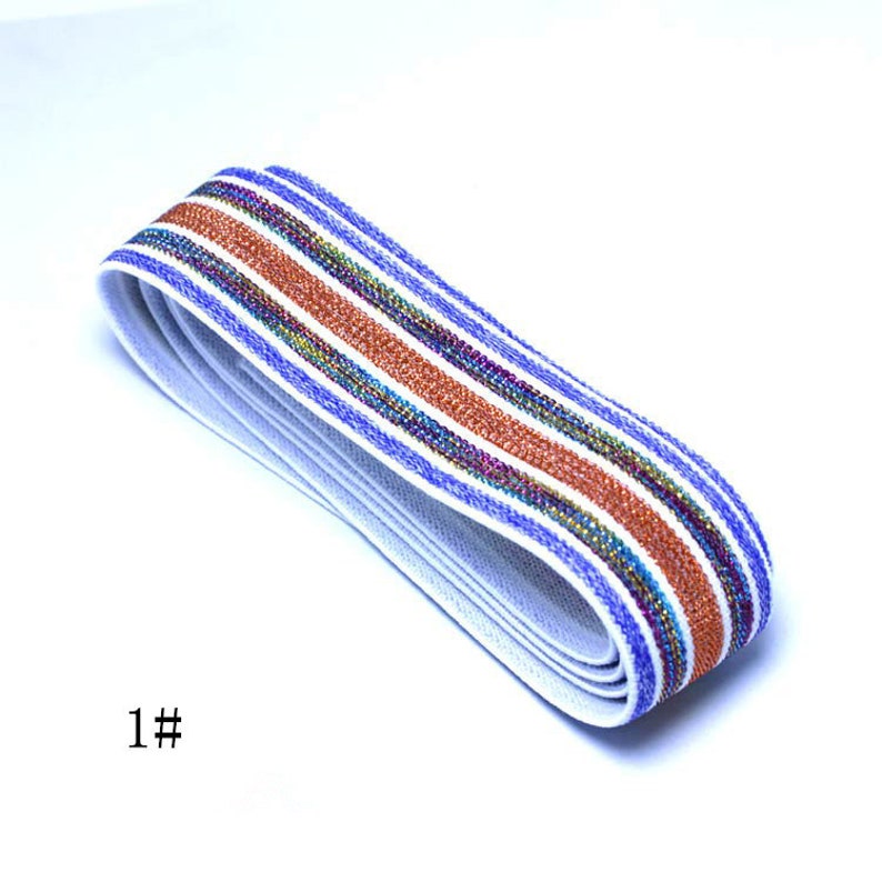 May include: White elastic band with blue and orange stripes with a shimmery finish. The elastic band is folded in half and the text "1#" is visible in the lower left corner of the image.