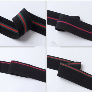 May include: Black elastic trim with red, green and blue stripes. The trim is folded and shown from different angles.