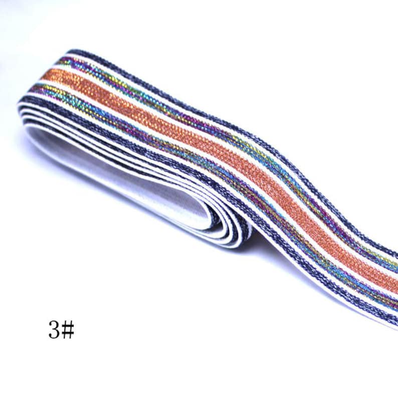 May include: White elastic band with blue, orange, and iridescent stripes. The band is folded in half and the text "3#" is visible in the lower left corner of the image.