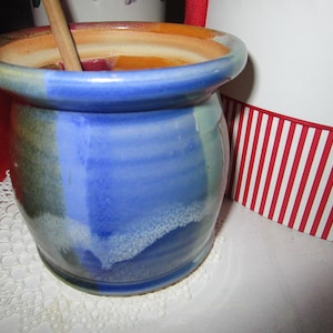 May include: A rustic wooden sign with the text "Welcome to our home" in white lettering. The sign features a distressed finish and a simple, inviting design, perfect for a front porch or entryway.