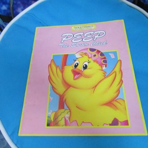 May include: A pink book with the title "GOOD TIMES" "PEEP The Easter Chick" and a cartoon illustration of a yellow chick hatching from an egg.