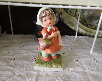 Vintage Porcelain Little Girl carrying a Basket on her arm Figurine