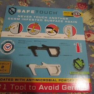 May include: A two-pack of white and black SafeTouch tools. The tools are designed to help avoid touching germ-infested surfaces. The tools have a variety of features, including a door opener, a bottle opener, a stylus, and a key ring attachment. The packaging says "SafeTouch" and "Never touch another germ infested surface again".