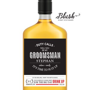 May include: Black and white groomsman label for a liquor bottle. The label says "Duty Calls. Will you be my groomsman Stephan adam + emily It's time to suit up. Your service is required for the big day. Drink up 07.21.18".