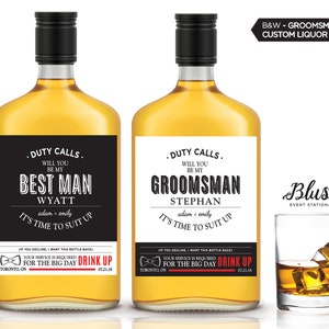 May include: Two black and white liquor bottle labels with the text "Duty Calls. Will you be my Best Man Wyatt" and "Duty Calls. Will you be my Groomman Stephan" with the text "adam + emily" and "It's time to suit up" below. The labels also include a bowtie icon and the text "Drink Up for the Big Day".