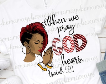 Op de afbeelding: Wit T-shirt met een rood-wit gestreept ontwerp met de tekst "Wanneer we bidden, hoort God. Jesaja 59:1". Een zwarte vrouw met rood haar bidt in het ontwerp.