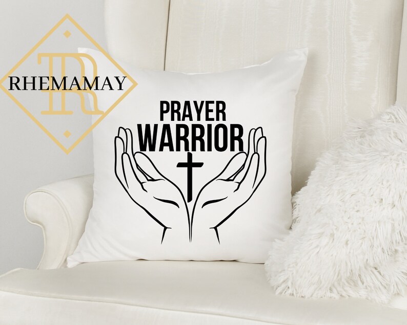 May include: White throw pillow with black text that reads "Prayer Warrior" and a black cross. The text is surrounded by two black hands in a praying position.
