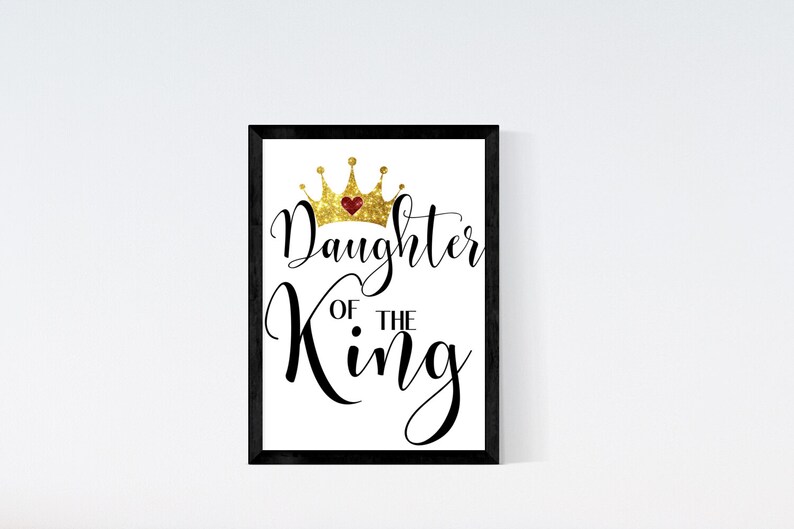 May include: A black framed print with a gold glitter crown and the text "Daughter of the King" in black cursive font.
