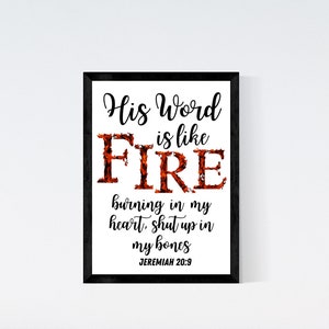 May include: A framed print with a white background and black frame. The print features a black and orange design with the text "His Word is like FIRE burning in my heart, shut up in my bones JEREMIAH 20:9".