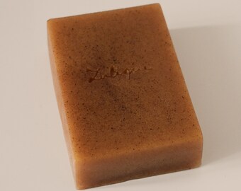 May include: A rectangular bar of brown soap with the word "Zubiq" embossed on the top.