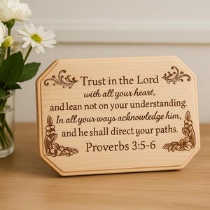 May include: A wooden plaque with a decorative floral design and the text "Trust in the Lord with all your heart, and lean not on your understanding: In all your ways acknowledge him, and he shall direct your paths. Proverbs 3:5-6"