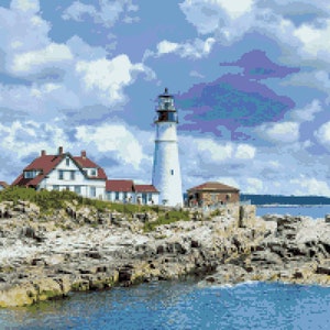 May include: A coastal scene featuring a white lighthouse with a black top, a red-roofed building, and a small stone structure. The structures sit on a rocky outcrop, with the ocean in the foreground and a cloudy blue sky above.