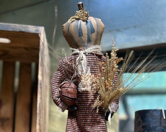 Pumpkin doll on stand