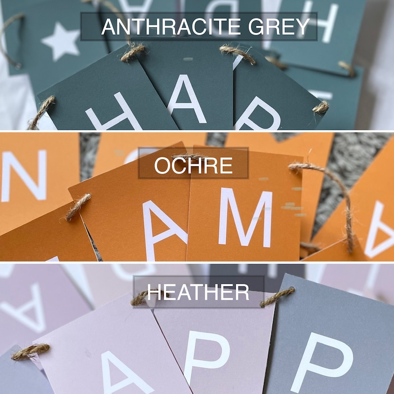 Puede incluir: Un banner con la palabra "Happy" escrita en letras blancas sobre banderas de papel de diferentes colores. Las banderas son de tres colores: gris antracita, ocre y brezo. Las banderas est&aacute;n unidas con un cordel.