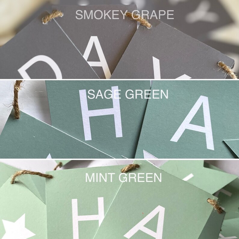 Puede incluir: Un banner con la palabra "Happy" escrita en letras blancas sobre tri&aacute;ngulos de papel verde y gris. Los tri&aacute;ngulos est&aacute;n unidos con un cordel. Los colores de los tri&aacute;ngulos son verde salvia, verde menta y uva ahumada.