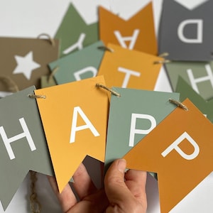 Golden coloured earth tones happy birthday garland/bunting featuring golden ochre, sunset orange and earthy greens.