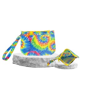 May include: Two tie-dye pattern pouches with yellow zippers and wrist straps. The larger pouch is rectangular, and the smaller one is square. The tie-dye design features swirls of blue, yellow, red, and green.