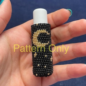 May include: A black beaded lip balm holder with a gold crescent moon and star design. The text "Pattern Only" is visible. The holder is designed to fit a standard lip balm tube.