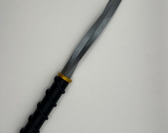 May include: A silver-colored dagger with a black and gold handle. The handle is wrapped in a spiral pattern.