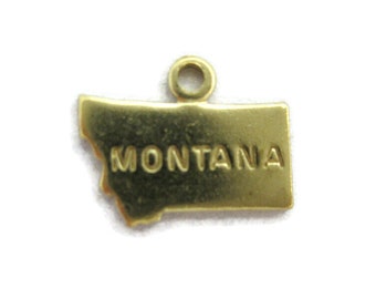 May include: A gold-colored charm in the shape of the state of Montana. The word "MONTANA" is embossed on the charm. The charm has a small loop at the top for attaching to a bracelet or necklace.