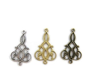 May include: Three ornate metal pendant charms in silver, gold, and black.