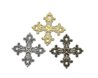 May include: Three ornate metal crosses in gold, silver, and antique brass finishes. Each cross features a detailed floral design.
