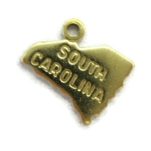 May include: Gold charm shaped like the state of South Carolina with the words "South Carolina" inscribed on it.