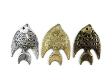 May include: Three metal fish charms in silver, gold, and bronze. Each fish has a detailed design with a textured surface.