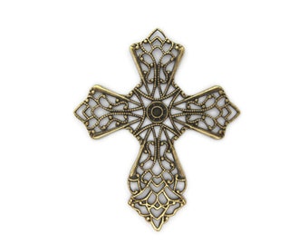 May include: Ornate, antique-style cross in a gold tone. The cross features an openwork design with intricate patterns and a central circular element. The edges have a decorative, scalloped shape. The cross is isolated on a white background.