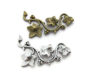 May include: Two metal ivy vine charms, one in antique gold and one in silver. Each charm features a delicate vine with five leaves.