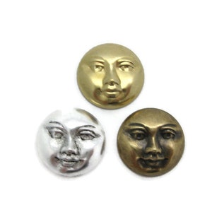 May include: Three round metal buttons with a face design. The buttons are in gold, silver, and bronze.
