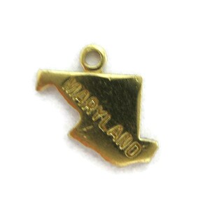 May include: Gold-colored metal charm shaped like the state of Maryland with the word "MARYLAND" inscribed on the charm.