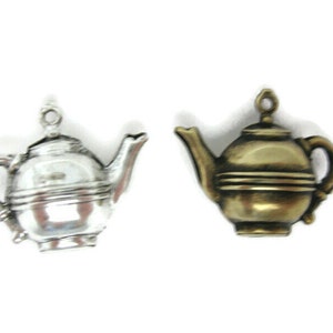 May include: Two silver and gold teapot charms. The silver teapot charm has a shiny finish. The gold teapot charm has a matte finish.