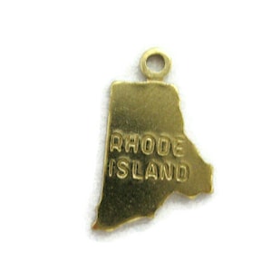 May include: Gold-colored charm shaped like the state of Rhode Island with the words "Rhode Island" inscribed on it.