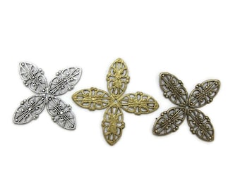 May include: Three metal filigree cross-shaped embellishments in silver, gold, and bronze tones. Each piece features an openwork design with intricate details, perfect for crafting and jewelry making.