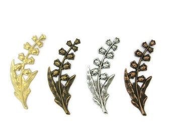 May include: Four metal lily of the valley flower charms in gold, bronze, silver, and copper finishes.