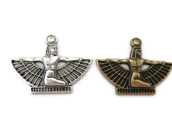 May include: Two silver and bronze pendants depicting an Egyptian goddess with outstretched wings. The goddess is wearing a crown and a headdress.