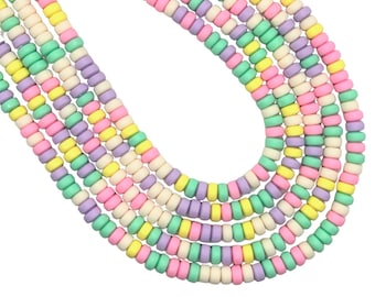 May include: Strands of pastel-colored beads in a variety of colors, including pink, yellow, green, purple, and white. The beads are small, round, and strung together to form multiple necklaces or strands. The beads are arranged in a curved pattern.
