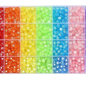 以下が含まれることがあります： 透明なプラスチック製のオーガナイザーにカラフルなビーズが詰まっています。ビーズは赤、オレンジ、黄色、緑、青、ピンク、紫など、色別に配置されています。各コンパートメントには文字入りのビーズが入っています。