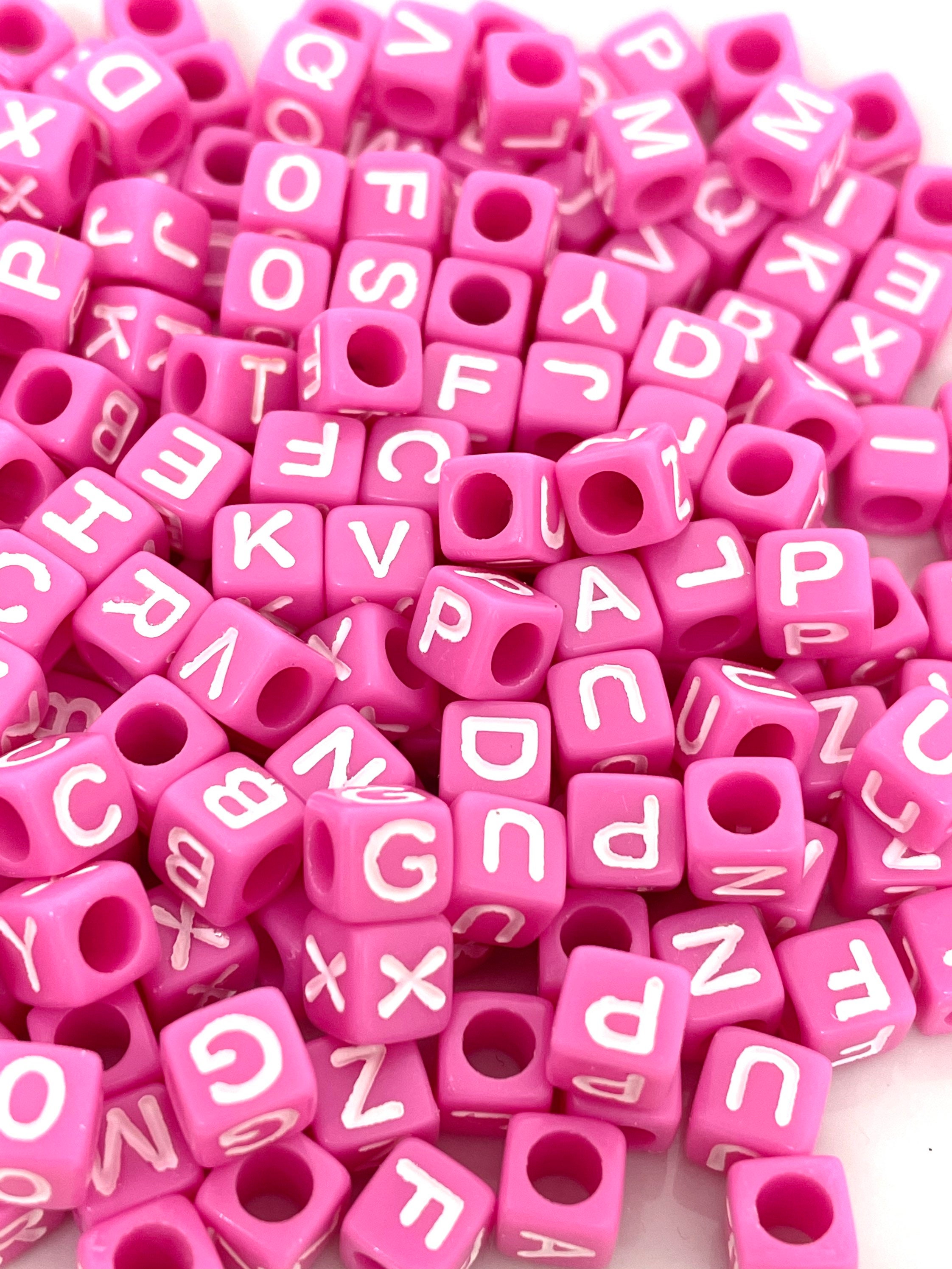 Acrylic beads, dice shaped, pink with black letters, 6x6x6mm, 20pcs