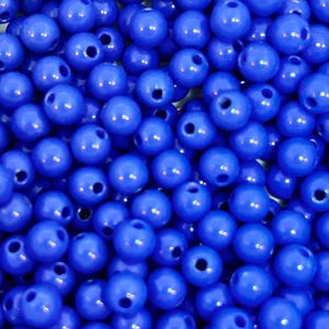 May include: A close-up image of a large quantity of small, round, blue beads. The beads are smooth and shiny, and they are all the same size.