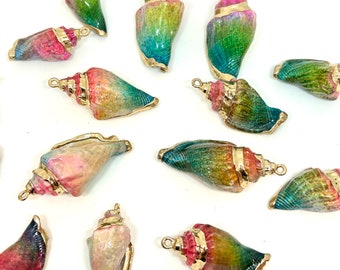 May include: A collection of 12 colorful seashell charms with gold accents. The shells are painted in shades of pink, green, blue, and yellow. Each shell has a gold loop for attaching to jewelry or other crafts.