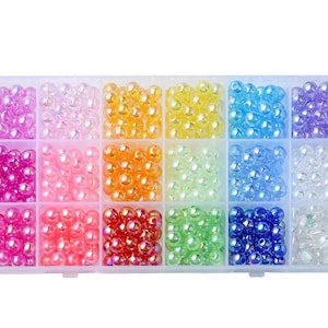 May include: A clear plastic storage box filled with 16 compartments of iridescent round beads in various colours, including pink, orange, yellow, green, blue, and purple.