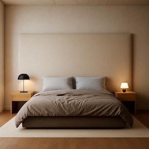May include: A modern bedroom setup featuring a bed with a large headboard, two bedside tables, and two lamps. The bed has a brown comforter and white pillows. The room has a neutral color palette with wooden floors and a rug.