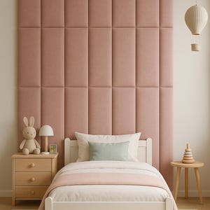 May include: A child's bedroom with a white bed, a wooden nightstand, and a pink upholstered headboard. A stuffed bunny, a small lamp, and a decorative hot air balloon are also visible. The bed has a light pink blanket and a green pillow.