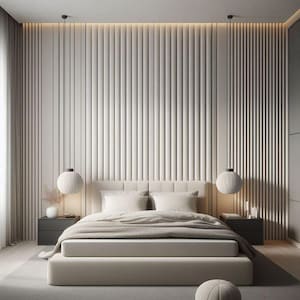 Op de afbeelding: Een wit bed met een beige hoofdeinde en een beige dekbed. Het bed staat in een slaapkamer met een witte muur en een wit plafond. Er hangen twee hanglampen aan het plafond.