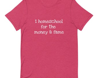 May include: A pink t-shirt with the text "I homeschool for the money & fame" in white.